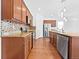 Spacious kitchen with stainless steel appliances, granite countertops, and wooden cabinets at 12742 E 104Th Dr, Commerce City, CO 80022