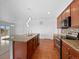 Bright kitchen with hardwood floors, a central island, modern appliances, and ample cabinet space at 12742 E 104Th Dr, Commerce City, CO 80022