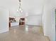 Open-concept living area features tile flooring and a view of the kitchen with modern appliances at 12742 E 104Th Dr, Commerce City, CO 80022