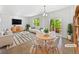 Bright, modern living room with stylish furniture, large windows, and sliding door to outdoor space at 12742 E 104Th Dr, Commerce City, CO 80022
