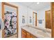 Bathroom with double sink vanity, large mirror, and separate toilet and shower room at 7624 S Cove Cir, Centennial, CO 80122