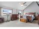 Spacious bedroom with vaulted ceilings, large windows, and wooden furniture at 7624 S Cove Cir, Centennial, CO 80122