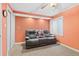 Cozy room with orange walls and carpeting with gray leather sofa at 7624 S Cove Cir, Centennial, CO 80122