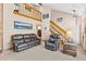 Spacious living room featuring a cozy leather sofa, lofted ceilings, and ample natural light at 7624 S Cove Cir, Centennial, CO 80122