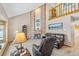 Inviting living room with soaring ceilings, brick fireplace, and natural light at 7624 S Cove Cir, Centennial, CO 80122