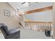 Open loft area with natural light, a comfortable chair, and views of the living space below at 7624 S Cove Cir, Centennial, CO 80122