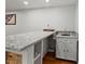 Basement bar area with granite countertop and under-counter storage at 8422 S Ault Ln, Morrison, CO 80465