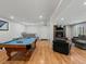 Spacious basement has a pool table, wet bar, fireplace, and comfortable seating area at 8422 S Ault Ln, Morrison, CO 80465