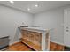 Basement bar featuring a granite countertop, tiled facade and convenient seating bench at 8422 S Ault Ln, Morrison, CO 80465