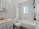 The bathroom features a combined shower and tub, and updated sink, toilet, and cabinets at 8422 S Ault Ln, Morrison, CO 80465