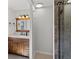 The bathroom features a vanity with a wooden cabinet and a tiled shower with a glass door at 8422 S Ault Ln, Morrison, CO 80465