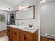 Bathroom boasts double vanity, wood cabinets, large mirror, and convenient laundry machines at 8422 S Ault Ln, Morrison, CO 80465