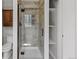 This bathroom has a glass shower stall, toilet, cabinet, and open shelving at 8422 S Ault Ln, Morrison, CO 80465