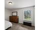 Bright bedroom with a large window showcasing an outdoor view and a wooden dresser at 8422 S Ault Ln, Morrison, CO 80465