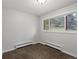 Empty bedroom features carpeted floors, white walls, and a bright window with natural light at 8422 S Ault Ln, Morrison, CO 80465