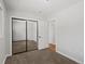 This bedroom features carpet, a closet with mirrored doors, and an ensuite at 8422 S Ault Ln, Morrison, CO 80465