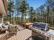 Wooden deck featuring outdoor seating, a BBQ grill, and a hot tub perfect for outdoor entertaining at 8422 S Ault Ln, Morrison, CO 80465