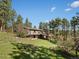 Beautiful home exterior with multiple decks and a lush, green lawn at 8422 S Ault Ln, Morrison, CO 80465