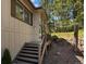 Exterior shot showcases a home's deck access and peaceful, wooded surroundings at 8422 S Ault Ln, Morrison, CO 80465
