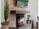 Close-up of a stone fireplace with wooden mantel, creating a cozy focal point in the living space at 8422 S Ault Ln, Morrison, CO 80465