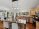 Bright kitchen showcases stainless steel appliances, a large island with bar seating, and a view into the dining area at 8422 S Ault Ln, Morrison, CO 80465