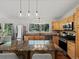 Well-lit kitchen with granite counters, wood cabinets, stainless appliances and large center island with seating at 8422 S Ault Ln, Morrison, CO 80465