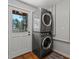Laundry area features stacked washer and dryer set and access to the outdoors at 8422 S Ault Ln, Morrison, CO 80465