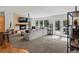 Bright living room boasts large windows, a stone fireplace, and comfortable seating at 8422 S Ault Ln, Morrison, CO 80465