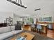 Open-concept living space featuring kitchen island, dining set, and a comfortable living room with plenty of natural light at 8422 S Ault Ln, Morrison, CO 80465