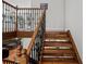 This staircase features wood treads and an ornate wrought iron and wood railing at 8422 S Ault Ln, Morrison, CO 80465