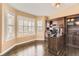 Well-lit office featuring a large wooden desk, built-in shelving, and bright windows at 6186 S Millbrook Way, Aurora, CO 80016