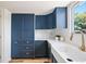 Modern kitchen with white quartz countertops and dark blue cabinetry at 9040 W Arizona Dr, Lakewood, CO 80232