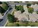 Expansive property featuring lush landscaping, a charming outbuilding, and a spacious driveway for multiple vehicles at 13950 E Chenango Dr, Aurora, CO 80015