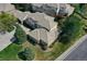 Stunning aerial view of a well-maintained home with mature trees and verdant lawns at 13950 E Chenango Dr, Aurora, CO 80015