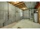 Unfinished basement with concrete walls offers versatile potential for customization and expansion at 13950 E Chenango Dr, Aurora, CO 80015