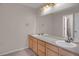 A shared bathroom features a double sink vanity and large mirror, perfect for busy mornings at 13950 E Chenango Dr, Aurora, CO 80015