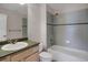 Bathroom with a combined shower and tub, grey tile, and a single sink vanity at 13950 E Chenango Dr, Aurora, CO 80015