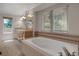 Well-lit bathroom featuring a soaking tub and vanity with double sinks at 13950 E Chenango Dr, Aurora, CO 80015