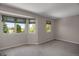 Bedroom with multiple windows with roller shades and neutral-toned carpet at 13950 E Chenango Dr, Aurora, CO 80015
