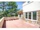 View of deck showcasing stone and stucco facade and large windows at 13950 E Chenango Dr, Aurora, CO 80015