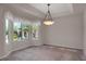 Bright dining room showcasing ample windows and a modern chandelier at 13950 E Chenango Dr, Aurora, CO 80015