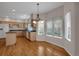 A Kitchen featuring hardwood floors, wood cabinets, and windows offering abundant natural light at 13950 E Chenango Dr, Aurora, CO 80015