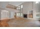 Open-concept living room with fireplace, high ceilings, and natural light at 13950 E Chenango Dr, Aurora, CO 80015