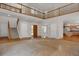 Spacious living room featuring an open staircase, hardwood floors, and abundant natural light at 13950 E Chenango Dr, Aurora, CO 80015
