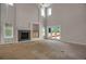 Open-concept living room features high ceilings, a fireplace, and access to an outdoor deck at 13950 E Chenango Dr, Aurora, CO 80015