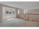 Open loft area with staircase, railing, large windows providing plenty of light at 13950 E Chenango Dr, Aurora, CO 80015