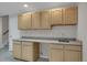 Close-up of entertainment space with wet bar, sink, and plenty of cabinet space at 13950 E Chenango Dr, Aurora, CO 80015
