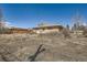 Backyard featuring a brick home, with mature trees and dry landscaping, ideal for customization at 2525 S Ivanhoe Pl, Denver, CO 80222