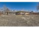 Backyard with a brick home, enclosed sunroom and mature trees, ready for landscaping and outdoor enjoyment at 2525 S Ivanhoe Pl, Denver, CO 80222