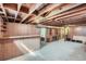 View of a basement with built in storage and an unfinished ceiling at 2525 S Ivanhoe Pl, Denver, CO 80222